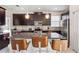 Beautiful kitchen featuring dark cabinets, stainless steel appliances, and a mosaic backsplash at 4740 Sleepy Hollow Dr, Kissimmee, FL 34746