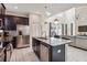 Open concept kitchen with granite island, stainless steel appliances, and seamless flow to living area at 4740 Sleepy Hollow Dr, Kissimmee, FL 34746