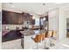 Modern kitchen with dark wood cabinetry, stainless steel appliances, and stylish breakfast bar at 4740 Sleepy Hollow Dr, Kissimmee, FL 34746
