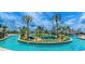 Gorgeous lazy river with tropical landscaping, various water features, and poolside seating at 4740 Sleepy Hollow Dr, Kissimmee, FL 34746