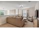Loft living area with a large sofa, stylish decor and lots of light from the window at 4740 Sleepy Hollow Dr, Kissimmee, FL 34746