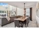Open living space with dining table featuring contemporary lighting and view of the living room at 4740 Sleepy Hollow Dr, Kissimmee, FL 34746