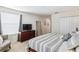 Spacious main bedroom with king bed, dresser with tv, and a view into hallway at 4740 Sleepy Hollow Dr, Kissimmee, FL 34746