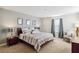 Bright main bedroom features a king bed, decorative mirrors, side tables, and neutral colors at 4740 Sleepy Hollow Dr, Kissimmee, FL 34746