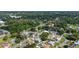 An aerial view showcases a lush neighborhood with mature trees and well-manicured lawns at 6198 Linneal Beach Dr, Apopka, FL 32703