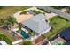 Aerial view of home with a pool, fire pit, lush landscaping, and a long driveway at 6198 Linneal Beach Dr, Apopka, FL 32703