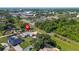 Aerial view of the home with a manicured lawn, pool, and mature trees in a neighborhood at 6198 Linneal Beach Dr, Apopka, FL 32703