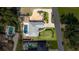 Aerial view of home with a pool, fire pit, lush landscaping, driveway, and neighboring houses at 6198 Linneal Beach Dr, Apopka, FL 32703