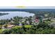 Aerial view of neighborhood homes surrounded by mature trees and adjacent to Bear Lake at 6198 Linneal Beach Dr, Apopka, FL 32703