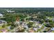 An aerial view showcases a lush neighborhood with mature trees and well-manicured lawns at 6198 Linneal Beach Dr, Apopka, FL 32703
