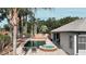 Aerial view of backyard oasis with pool, hot tub, palm trees, and landscaping at 6198 Linneal Beach Dr, Apopka, FL 32703