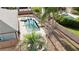 An aerial view highlights a backyard pool and spa, complemented by a fire pit and lush landscaping at 6198 Linneal Beach Dr, Apopka, FL 32703