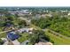 Aerial view of the home with a manicured lawn, pool, and mature trees in a neighborhood at 6198 Linneal Beach Dr, Apopka, FL 32703
