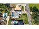 Aerial view of home with a pool, fire pit, lush landscaping, driveway, and neighboring houses at 6198 Linneal Beach Dr, Apopka, FL 32703