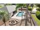 An aerial view highlights a backyard pool and spa, complemented by a fire pit and lush landscaping at 6198 Linneal Beach Dr, Apopka, FL 32703