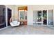 Outdoor seating area on the back patio with travertine floors and a view of the backyard at 6198 Linneal Beach Dr, Apopka, FL 32703