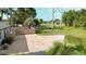 Open backyard features a private fence, concrete patio, lawn, and mature trees and shrubs at 6198 Linneal Beach Dr, Apopka, FL 32703
