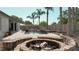 A backyard pool and fire pit are surrounded by lush landscaping and a privacy fence at 6198 Linneal Beach Dr, Apopka, FL 32703