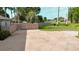 Open backyard features a private fence, concrete patio, lawn, and mature trees and shrubs at 6198 Linneal Beach Dr, Apopka, FL 32703
