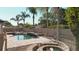 A backyard pool and fire pit are surrounded by lush landscaping and a privacy fence at 6198 Linneal Beach Dr, Apopka, FL 32703