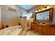 Spa-like bathroom with jetted tub, stone shower, and elegant vanity at 6198 Linneal Beach Dr, Apopka, FL 32703