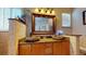 Bathroom with dual sinks, granite counters, brick accent wall and natural light at 6198 Linneal Beach Dr, Apopka, FL 32703