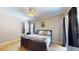 Bedroom featuring a comfortable bed, neutral decor, and ample natural light at 6198 Linneal Beach Dr, Apopka, FL 32703