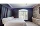 Bedroom featuring a stone accent wall, ceiling fan and window at 6198 Linneal Beach Dr, Apopka, FL 32703