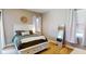 Cozy bedroom featuring neutral walls, large windows, and an accent mirror at 6198 Linneal Beach Dr, Apopka, FL 32703