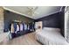 Modern bedroom with walk-in closet, hardwood floors, and a ceiling fan at 6198 Linneal Beach Dr, Apopka, FL 32703