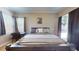 Comfortable bedroom featuring large bed, neutral tones, and backyard access via sliding glass doors at 6198 Linneal Beach Dr, Apopka, FL 32703