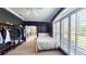 Bedroom featuring a ceiling fan, large window and clothing rack at 6198 Linneal Beach Dr, Apopka, FL 32703