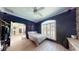 Bedroom featuring a stone accent wall, ceiling fan and window at 6198 Linneal Beach Dr, Apopka, FL 32703
