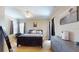 Comfortable bedroom with a large bed, dresser, and soft lighting at 6198 Linneal Beach Dr, Apopka, FL 32703