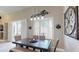 Dining area features a modern light fixture and a view of the backyard at 6198 Linneal Beach Dr, Apopka, FL 32703