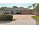 The rear exterior shows a long, paved driveway and the rear facade of the home at 6198 Linneal Beach Dr, Apopka, FL 32703