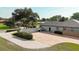 A large concrete driveway is adjacent to the rear exterior of this block-wall home at 6198 Linneal Beach Dr, Apopka, FL 32703