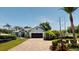 Beautiful single-story house with a brick driveway, lush landscaping, and a well-maintained lawn at 6198 Linneal Beach Dr, Apopka, FL 32703