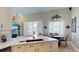 The kitchen flows into the dining area and features white cabinetry and a breakfast bar at 6198 Linneal Beach Dr, Apopka, FL 32703
