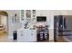 Well-equipped kitchen with stainless steel appliances, wine rack and bright white cabinetry at 6198 Linneal Beach Dr, Apopka, FL 32703