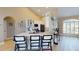 Bright, renovated kitchen with white cabinets, quartz countertops, a breakfast bar, and stainless steel appliances at 6198 Linneal Beach Dr, Apopka, FL 32703