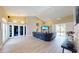 Bright and airy living room featuring wood floors, neutral walls, and access to the outdoors through glass doors at 6198 Linneal Beach Dr, Apopka, FL 32703