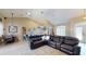 Large living room with an open floor plan that transitions to the kitchen and dining room with wood floors and light-colored walls at 6198 Linneal Beach Dr, Apopka, FL 32703