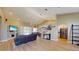 Spacious open-concept living room featuring wood floors, vaulted ceilings, and a seamless transition to the dining area at 6198 Linneal Beach Dr, Apopka, FL 32703