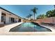 Pool with travertine deck surrounded by a fence and palm trees at 6198 Linneal Beach Dr, Apopka, FL 32703