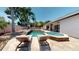 Poolside lounge chairs near a pool and patio with palm trees at 6198 Linneal Beach Dr, Apopka, FL 32703