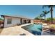 Backyard pool with a hot tub and seating area with palm trees at 6198 Linneal Beach Dr, Apopka, FL 32703