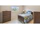 Cozy bedroom featuring a twin bed with floral bedding and a chest of drawers with lots of storage at 620 Marshall St, Altamonte Springs, FL 32701