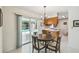 Dining room next to kitchen with chandelier and sliding glass doors view of pool at 620 Marshall St, Altamonte Springs, FL 32701