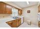 The kitchen features wood cabinets, a double basin sink, and floral wallpaper at 620 Marshall St, Altamonte Springs, FL 32701
